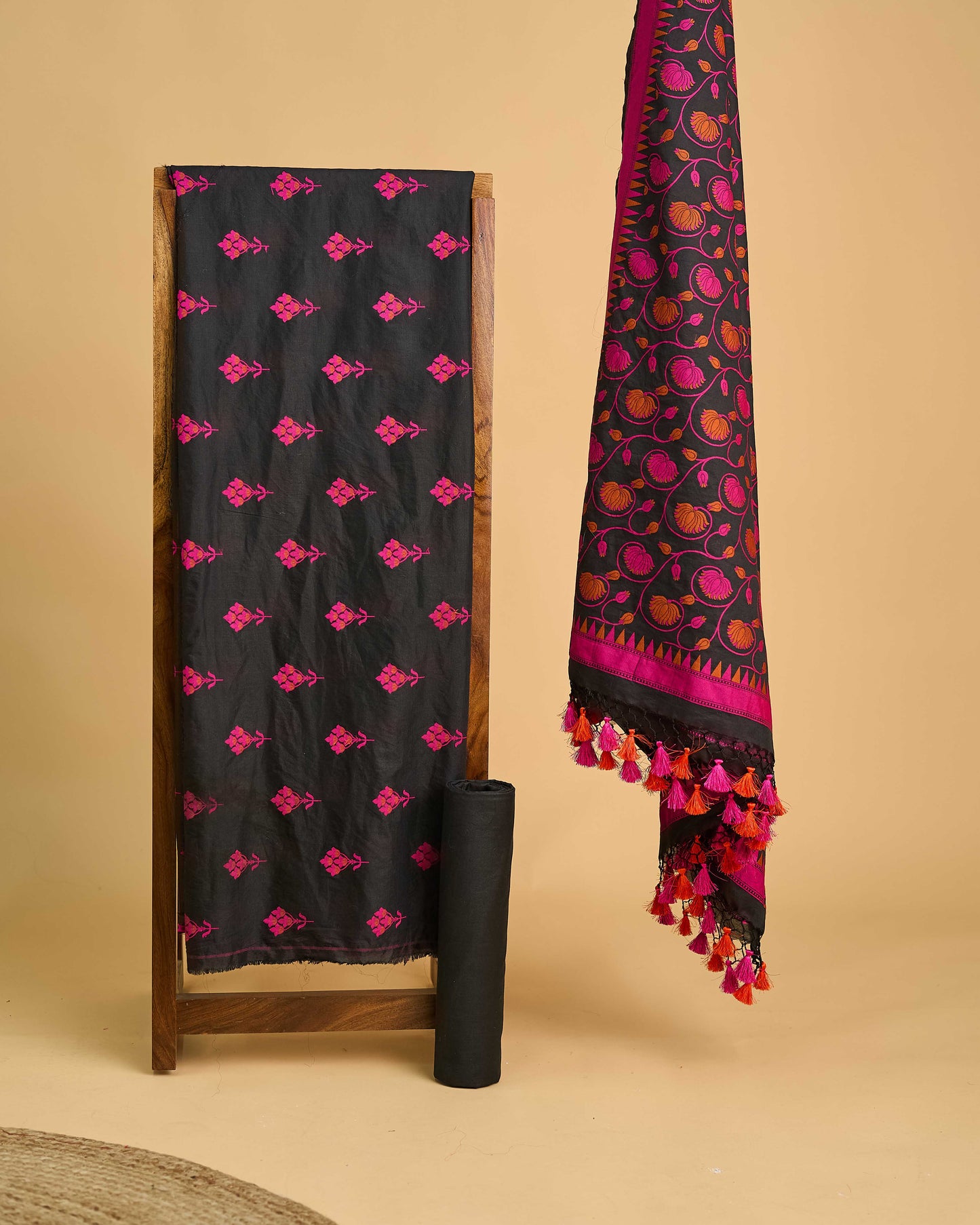Black chanderi with pink meenadar bootis, jaal dupatta, plain bottom.