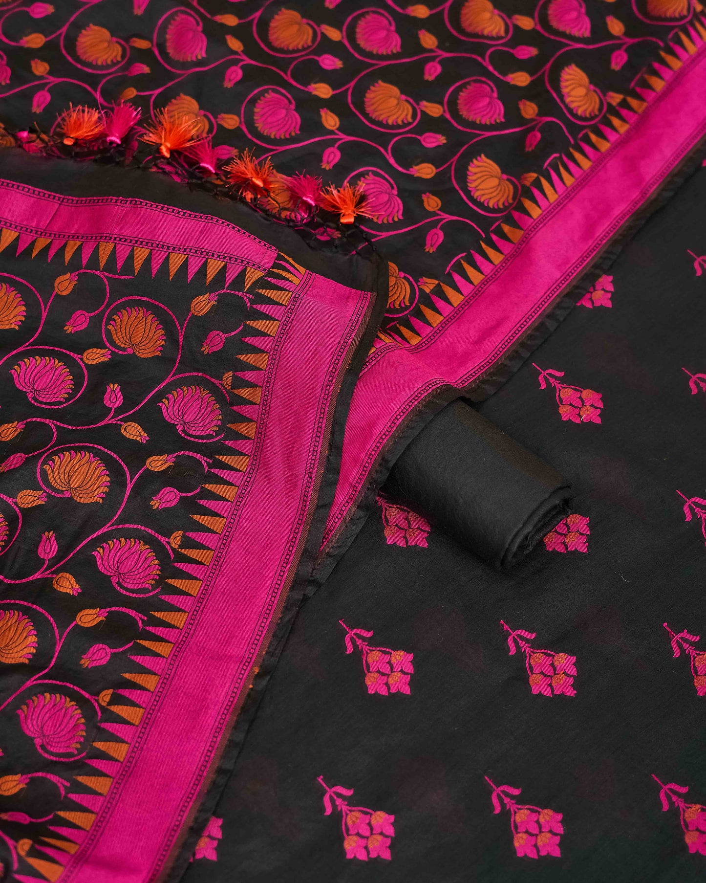 Black chanderi with pink meenadar bootis, jaal dupatta, plain bottom.