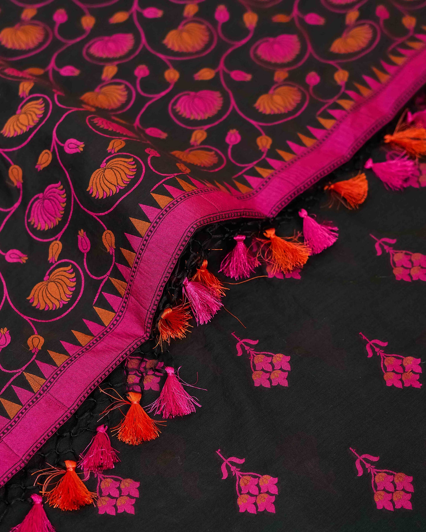 Black chanderi with pink meenadar bootis, jaal dupatta, plain bottom.