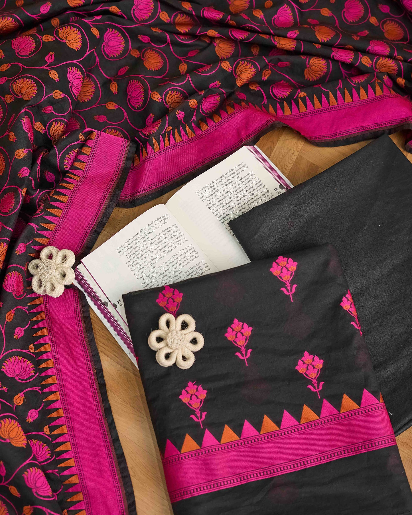 Black chanderi with pink meenadar bootis, jaal dupatta, plain bottom.