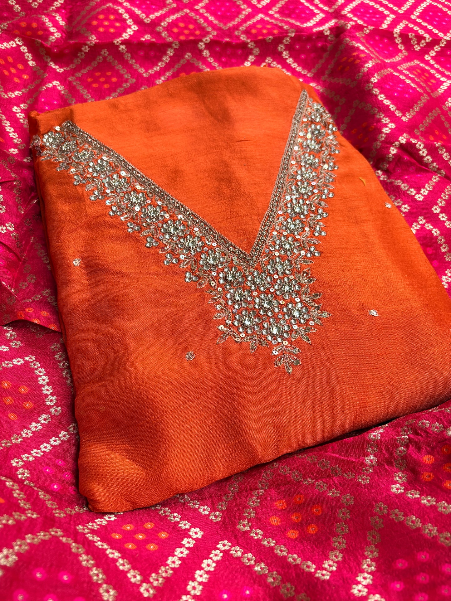 Orange hand embroidered kurta, red bandhani dupatta , plain bottom