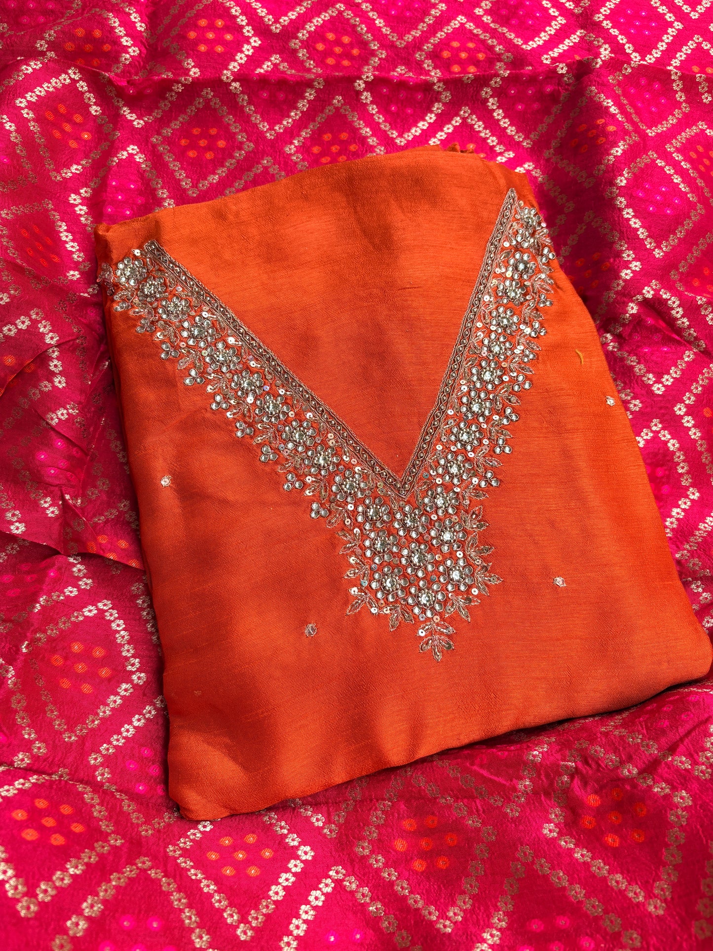 Orange hand embroidered kurta, red bandhani dupatta , plain bottom