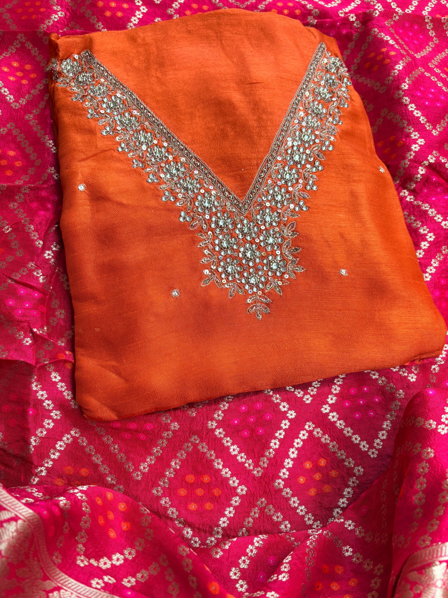 Orange hand embroidered kurta, red bandhani dupatta , plain bottom