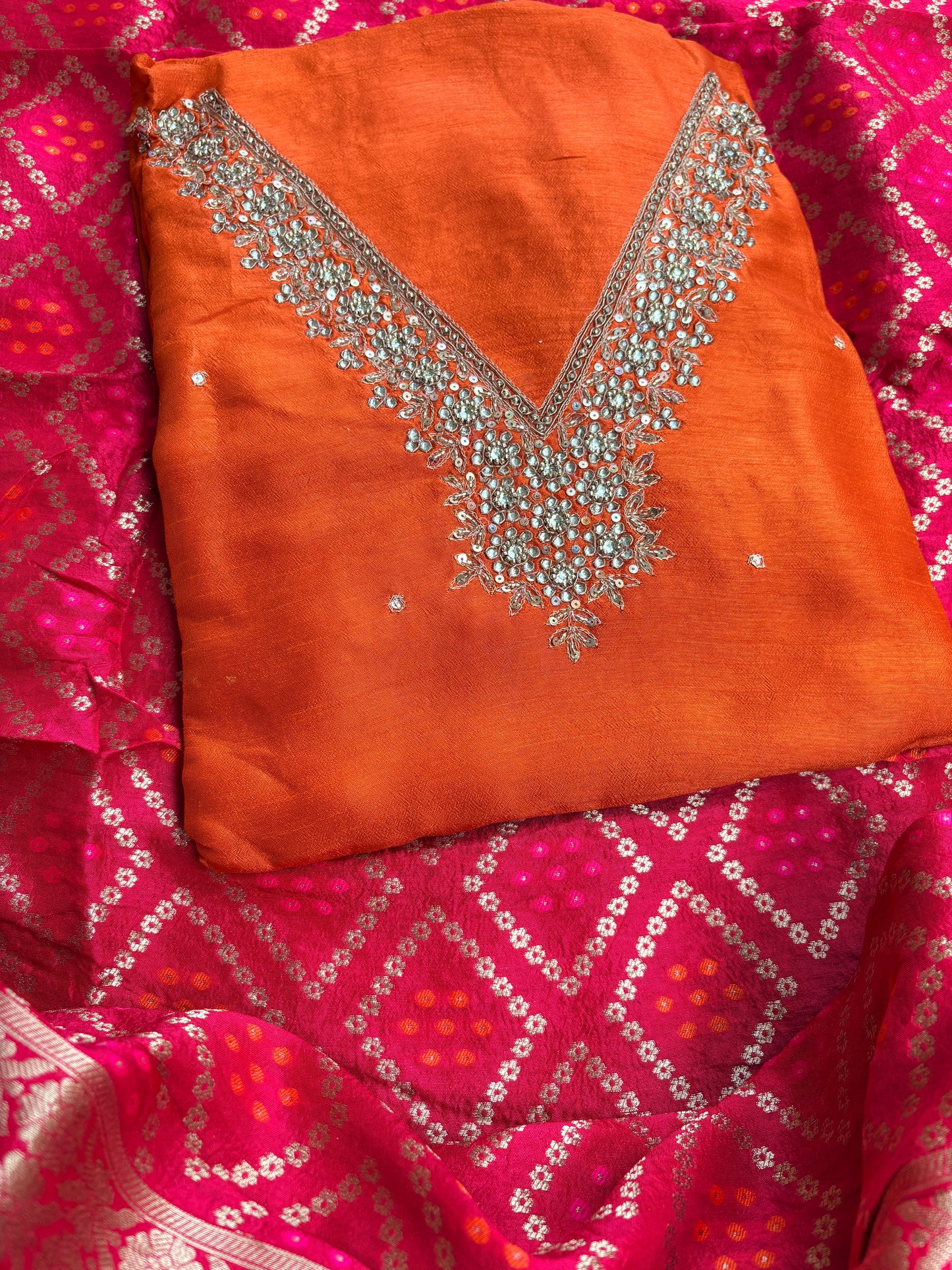 Orange hand embroidered kurta, red bandhani dupatta , plain bottom